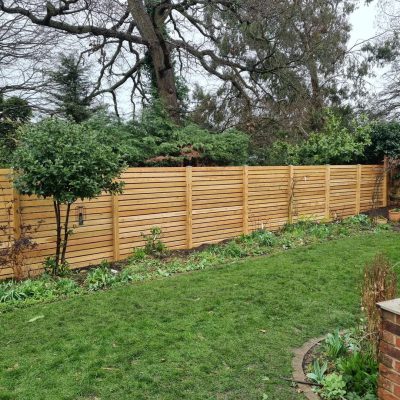 Horizontal slatted timber garden fence