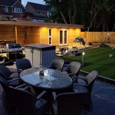 Clad garden room with timber fencing and patio