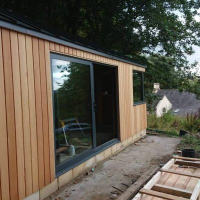Vertical board cladding on a garden office